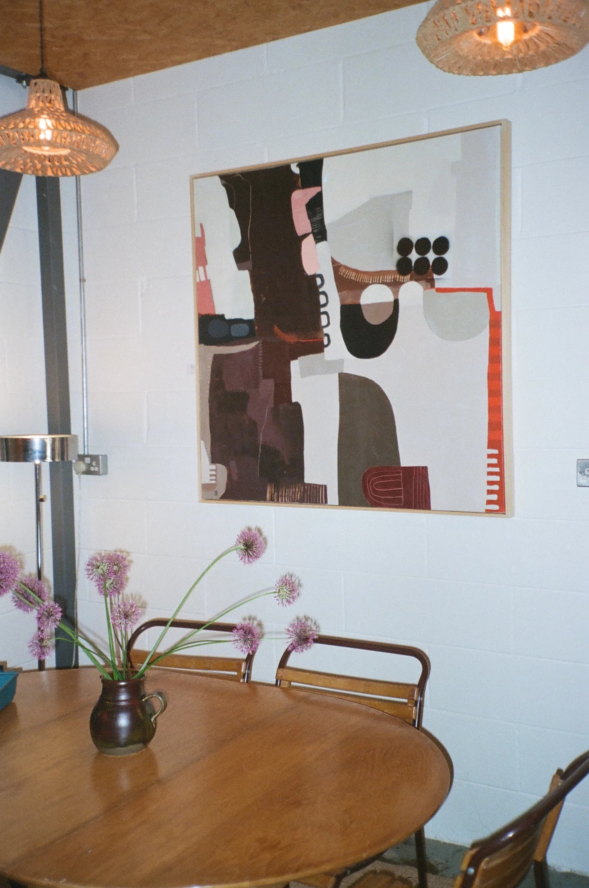 PRANA HOUSE wall art, pendant lights, flowers, and timber table