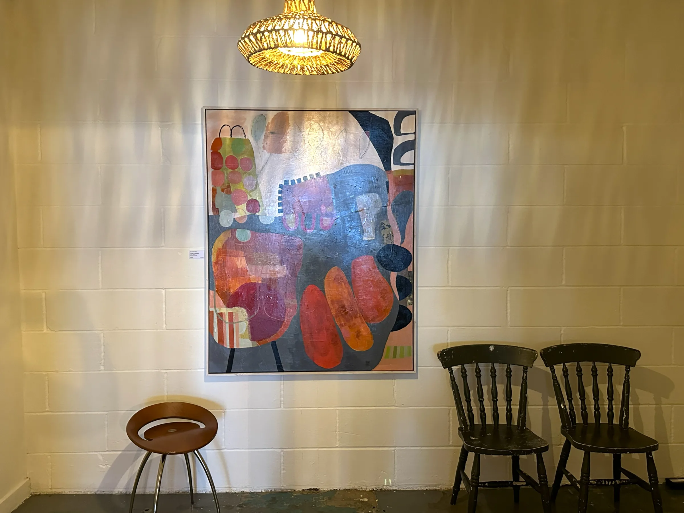 Warm wall art and pendant light inside Prana House
